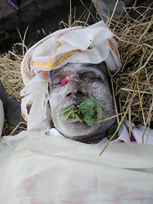Face of a dead man with leaves in his mouth, India