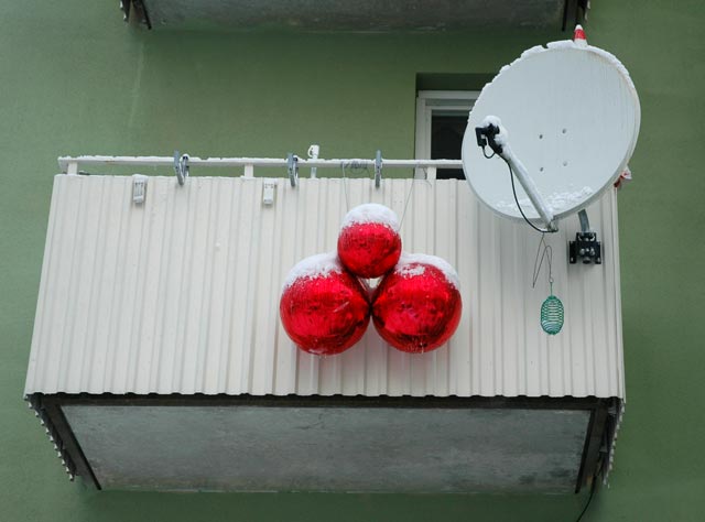 red balloons and parabol disc on balcony with snow winter
