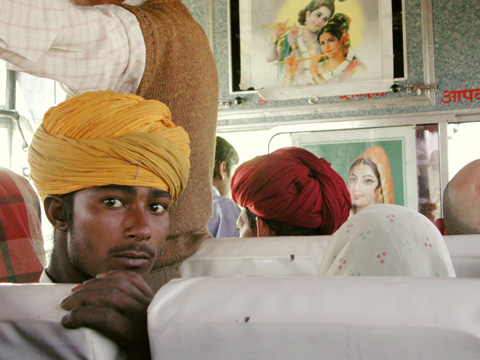 man with yellow turban travelling in bus in northern india