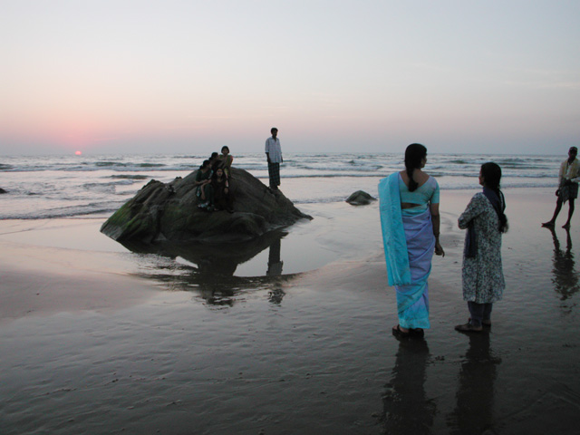 woman in blue sari by sunset indian ocean Gokarna india