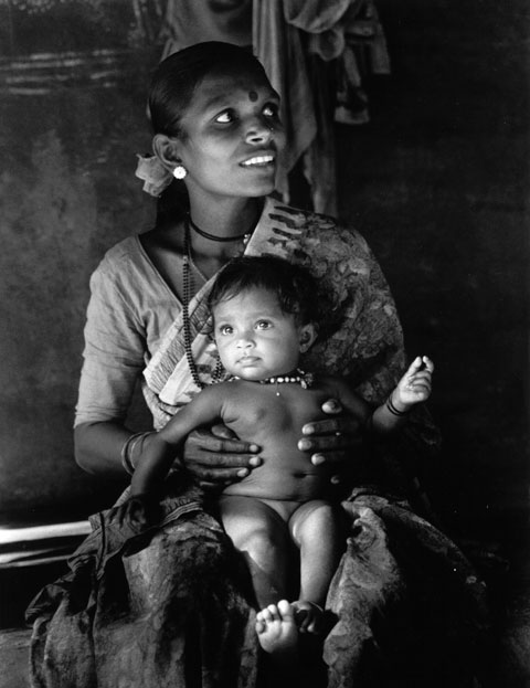 Mother with child in her lap, beautiful eyes both look very happy, India Kudle