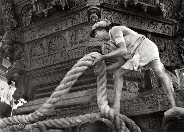man with huge rope on the holy chariot, Ratta, preparing for the Shiva Ratri festival Gokarna Karnataka India