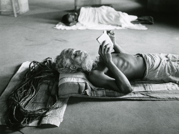 Sadhu reading a book Long hair placed on a mat