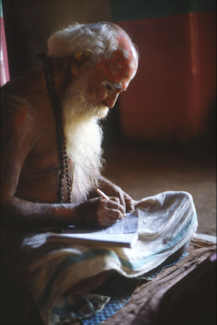 Sadhu writing om namo shiva rama temple Gokarna India