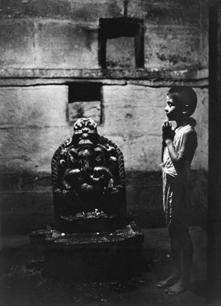 Brahmin boy praying in side light in Shiva temple Gokarna
