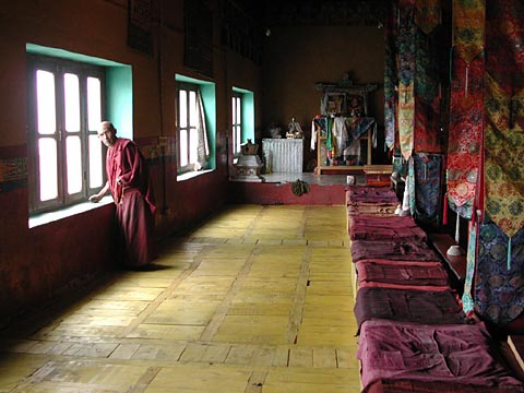 Tibetan monk by window in a monastery