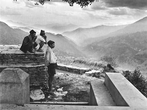 Sunset in the Himalayas, three men watching the mountains at sunset