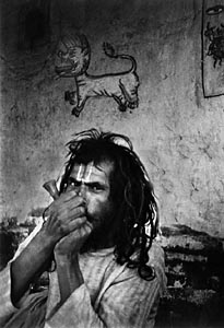Sadhu, a holy man smoking hashis in a chillum