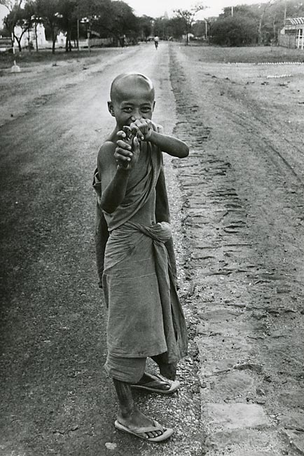 Buddhist young monk with catapult slingshot