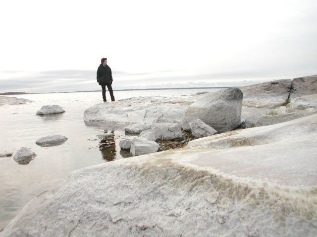 Stockkholm archipelago, woman standing on white cliffs