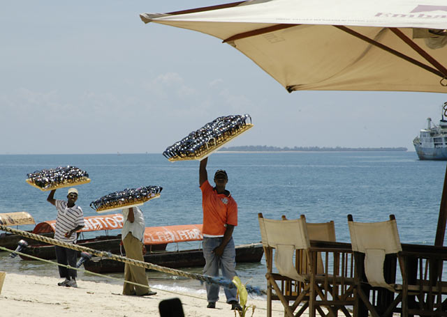 Three men selling sun glasses in Stone town Zanzibar