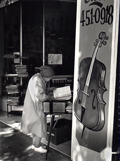 woman reading notes by a chello poster
