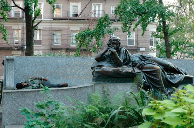 man sleeping on a statue in straus park upper west side sleep rest