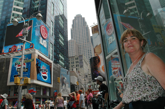 times square woman standing next to ads sun burnt tan sensual dramatic