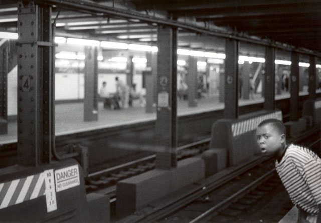 New York subway. Boy looking for upcoming train