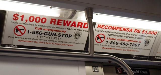 Poster in New York subway announcing one thousand dollar reward to report an illegal gun