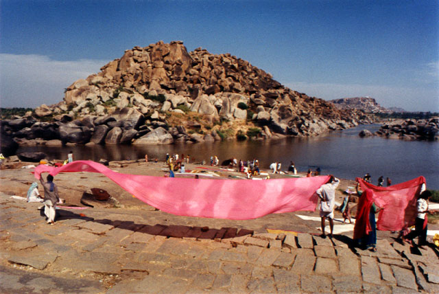 hampi huge boulders red sari dry in the wind